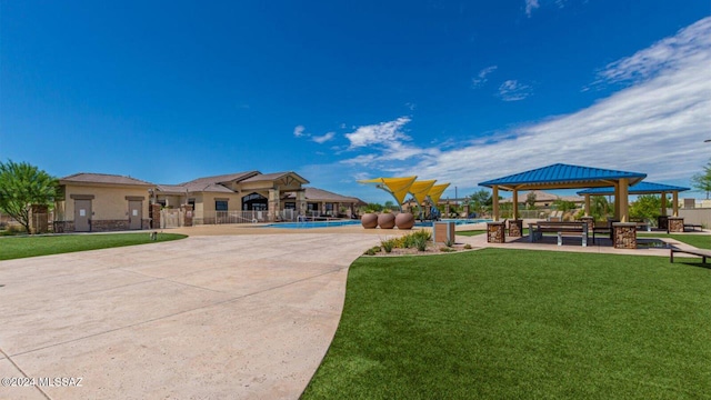 view of home's community with a gazebo and a yard