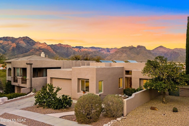 southwest-style home featuring a mountain view and a garage