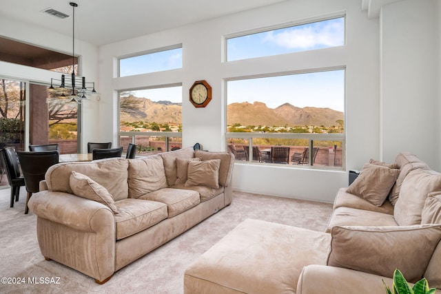 living room with carpet flooring, a mountain view, and a high ceiling