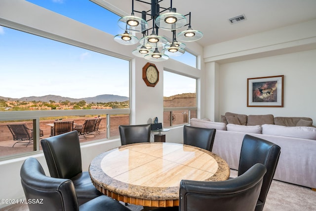 dining area featuring a mountain view and a chandelier