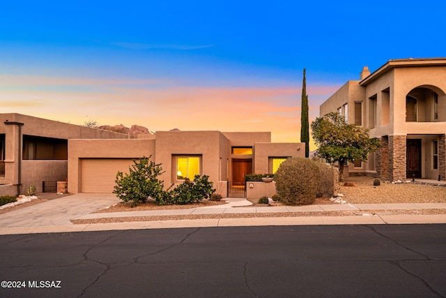 pueblo-style home with a garage