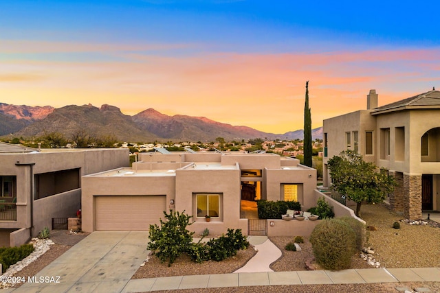 adobe home with a mountain view and a garage