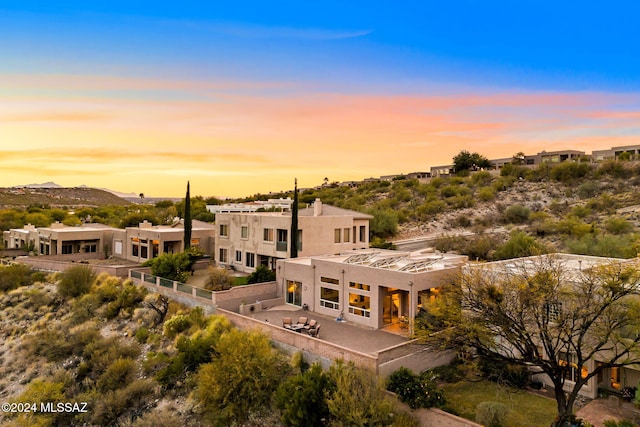 view of back house at dusk