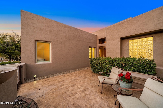 view of patio terrace at dusk