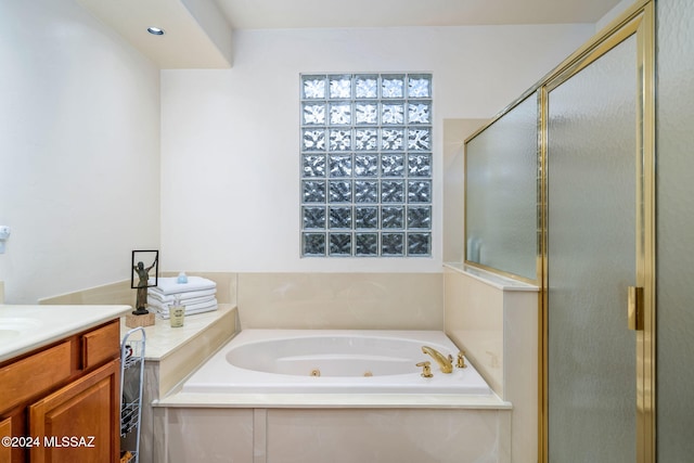 bathroom featuring vanity and independent shower and bath