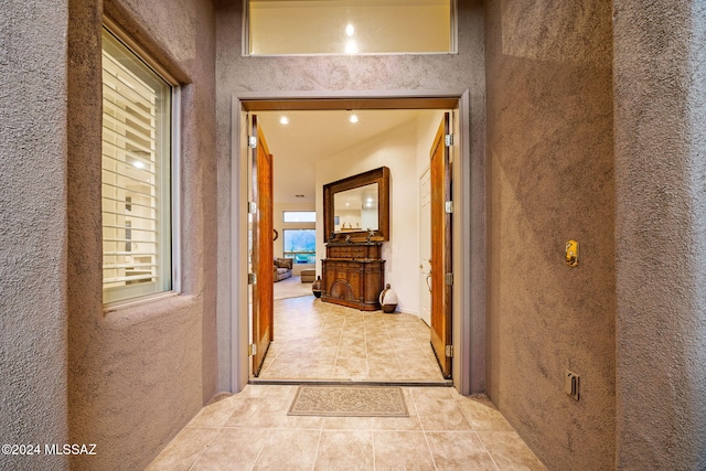 hall with light tile patterned floors