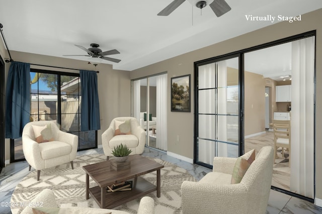 sitting room featuring ceiling fan