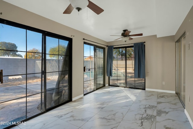 spare room featuring a wealth of natural light and ceiling fan