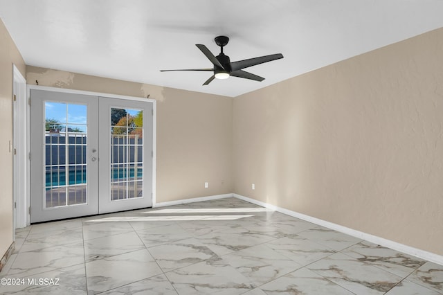 unfurnished room featuring ceiling fan and french doors