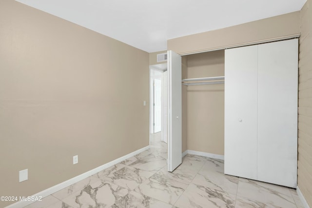 unfurnished bedroom with a closet