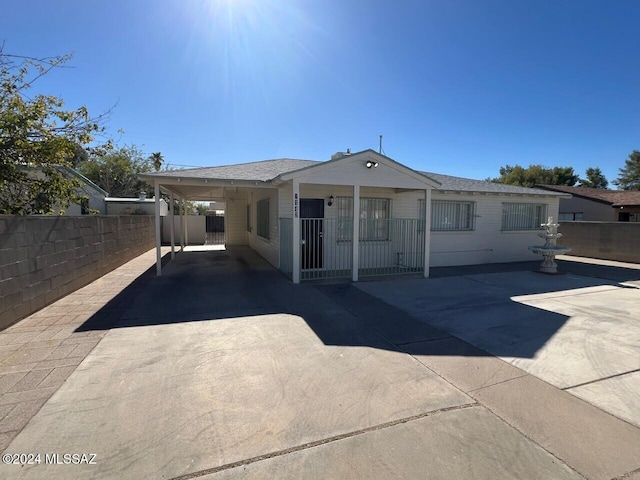 back of property with a carport