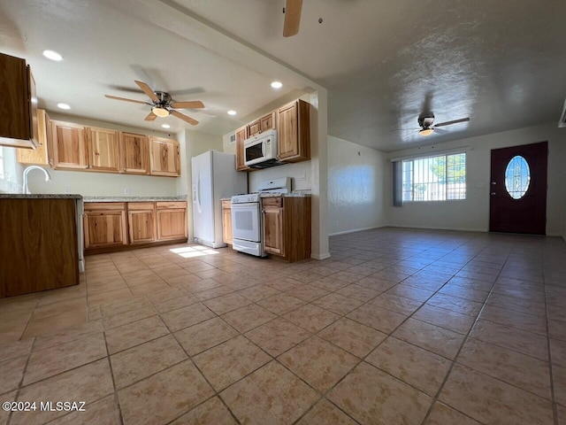 kitchen featuring ceiling fan, light stone countertops, light tile patterned flooring, and white appliances