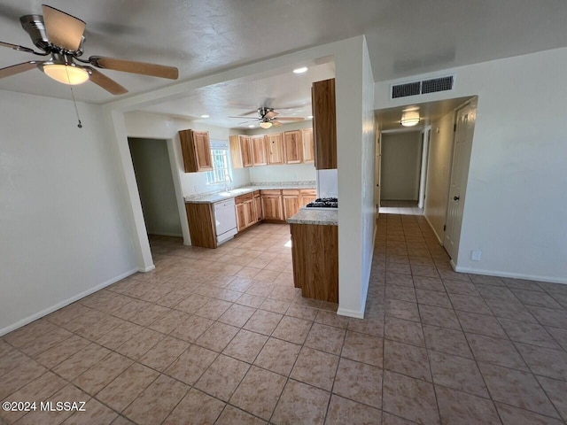 kitchen with sink, a textured ceiling, light tile patterned floors, white dishwasher, and ceiling fan