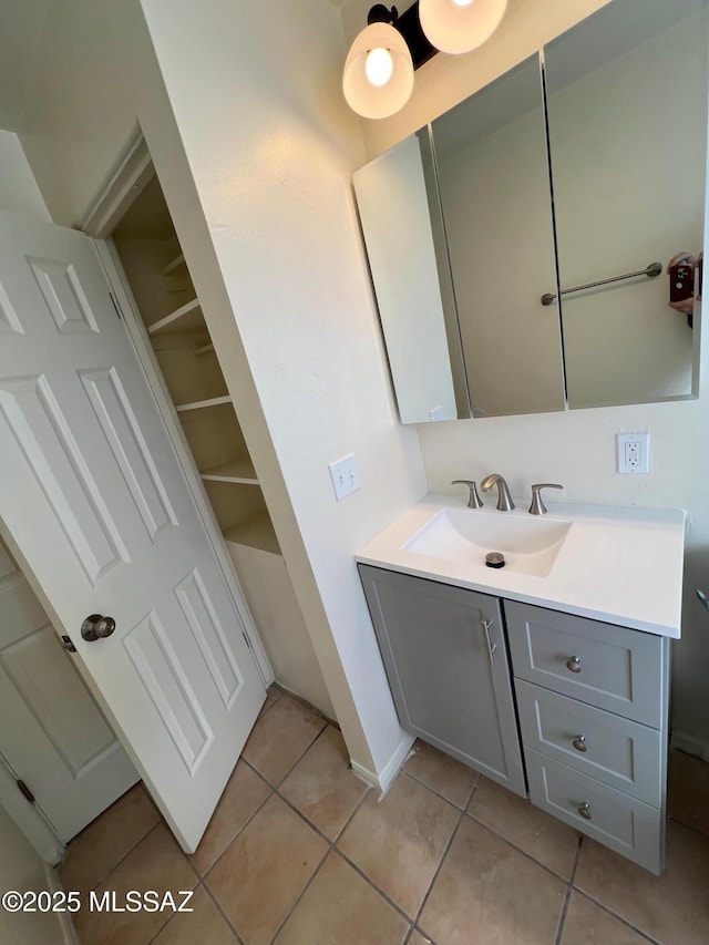 bathroom featuring tile patterned flooring and vanity