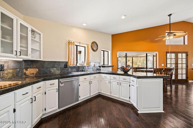 kitchen with dishwasher, a sink, a ceiling fan, a peninsula, and vaulted ceiling