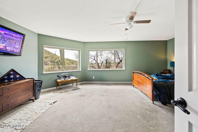 bedroom featuring ceiling fan, baseboards, and carpet