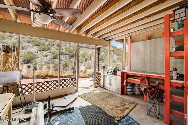 sunroom with a ceiling fan