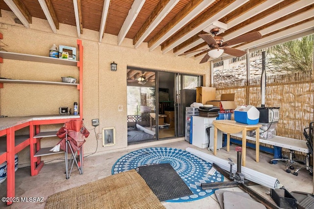 view of patio / terrace with fence and a ceiling fan