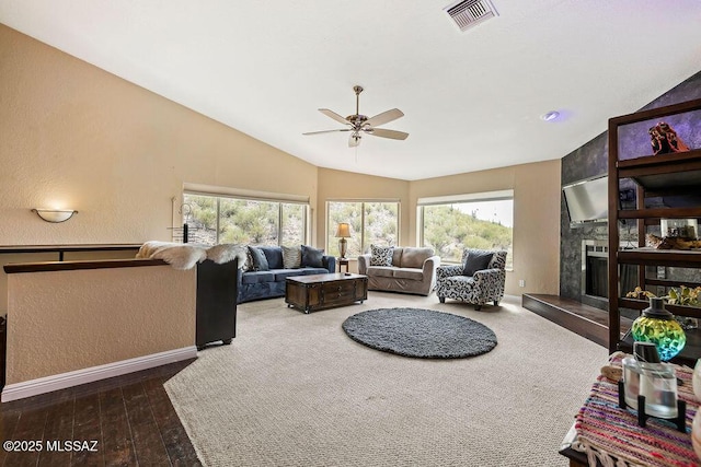 living room with ceiling fan, a large fireplace, visible vents, and a wealth of natural light
