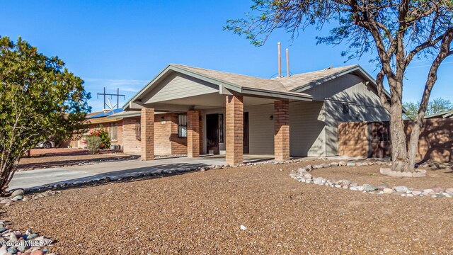 view of front of home featuring solar panels and a carport