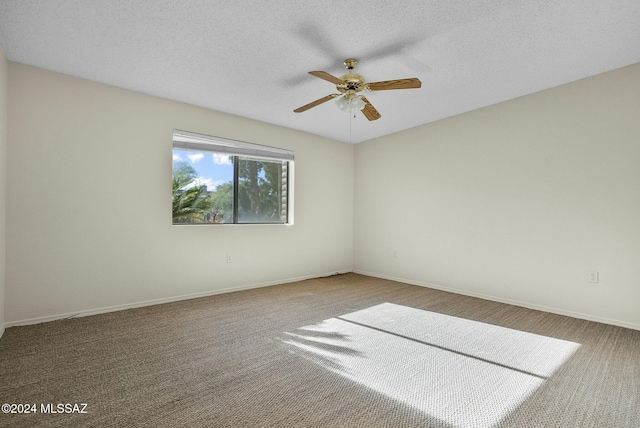 spare room featuring a textured ceiling, carpet floors, and ceiling fan