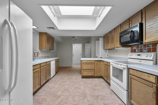 laundry room with light tile patterned floors, cabinets, and washer / dryer