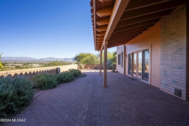 view of patio / terrace with a mountain view and french doors