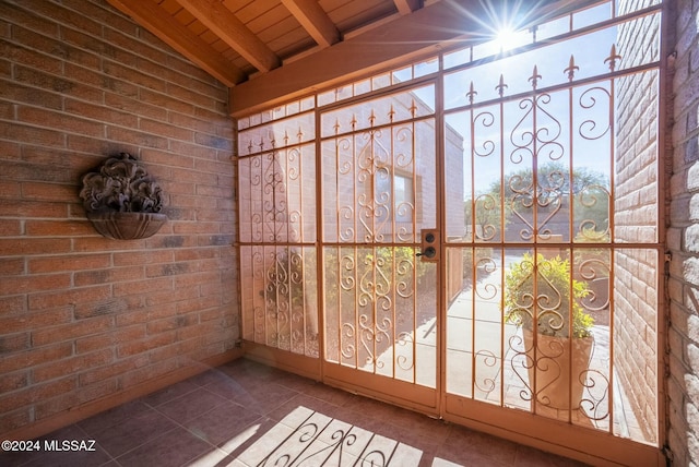 unfurnished sunroom featuring wooden ceiling and lofted ceiling with beams