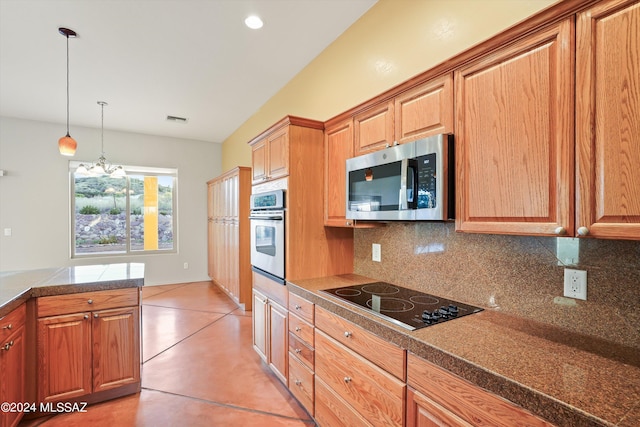 kitchen with pendant lighting, a notable chandelier, decorative backsplash, and appliances with stainless steel finishes