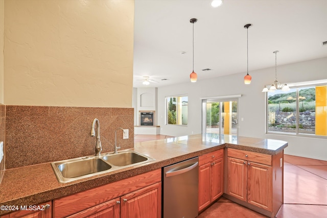 kitchen with tasteful backsplash, ceiling fan with notable chandelier, sink, decorative light fixtures, and dishwasher