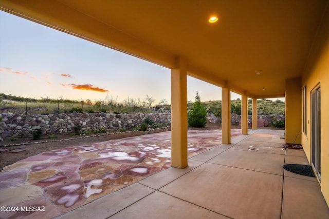 view of patio terrace at dusk