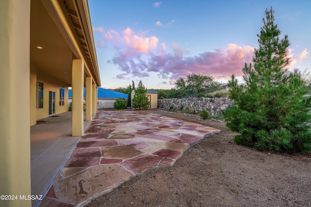 view of patio terrace at dusk