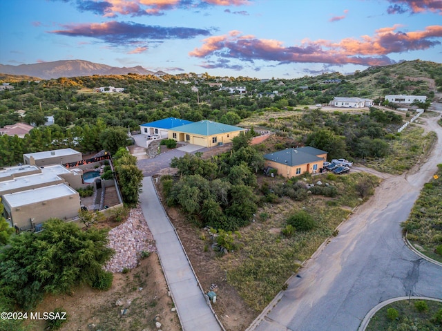 aerial view at dusk featuring a mountain view