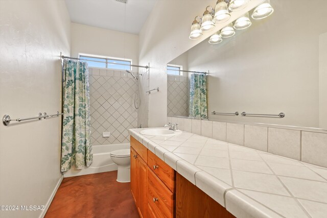 full bathroom with shower / tub combo with curtain, vanity, and toilet