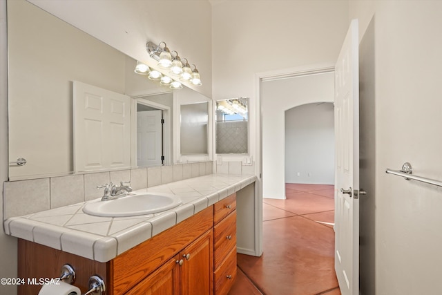 bathroom featuring tasteful backsplash and vanity