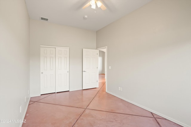 unfurnished bedroom with tile patterned flooring, a closet, and ceiling fan