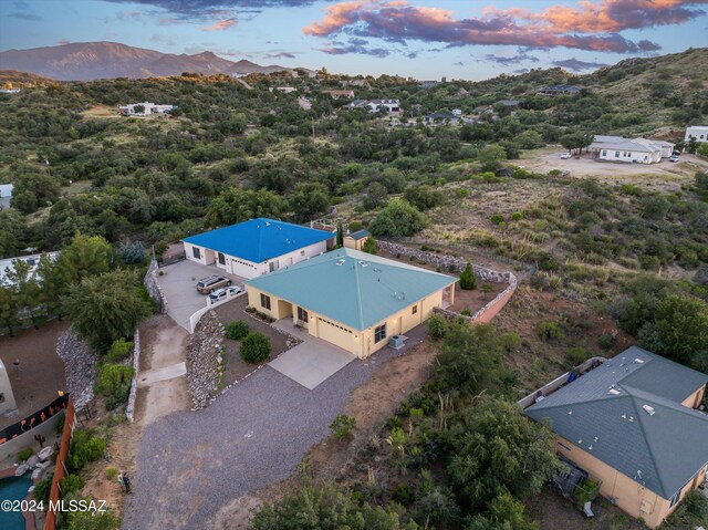 aerial view at dusk featuring a mountain view