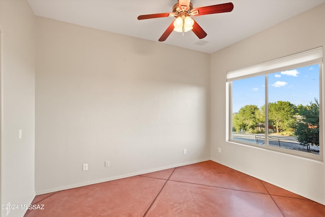 tiled empty room featuring ceiling fan