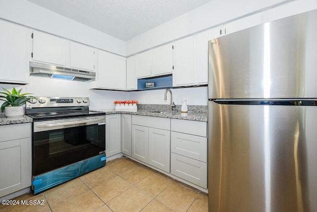 kitchen featuring light tile patterned floors, white cabinetry, sink, and appliances with stainless steel finishes