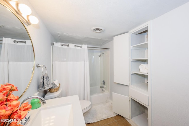 bathroom with toilet, vanity, visible vents, tile patterned floors, and shower / bath combo