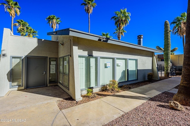 back of house with stucco siding