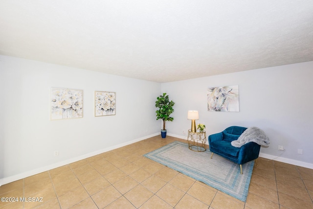 living area with tile patterned floors