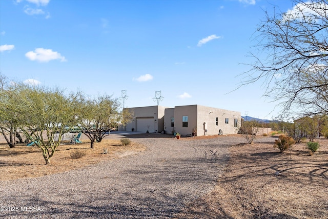 view of front of house featuring a garage and a playground