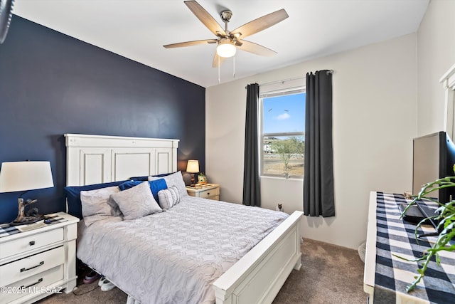 bedroom featuring ceiling fan and dark carpet