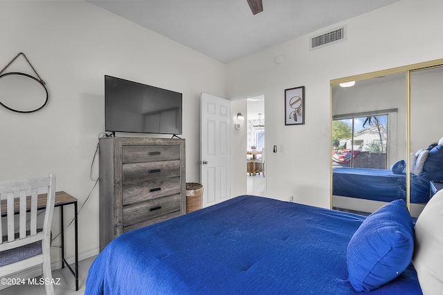 bedroom with a ceiling fan, wood finished floors, and visible vents