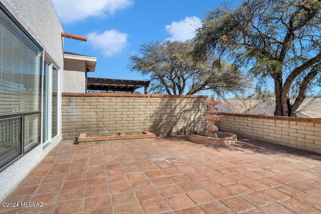 view of patio featuring fence