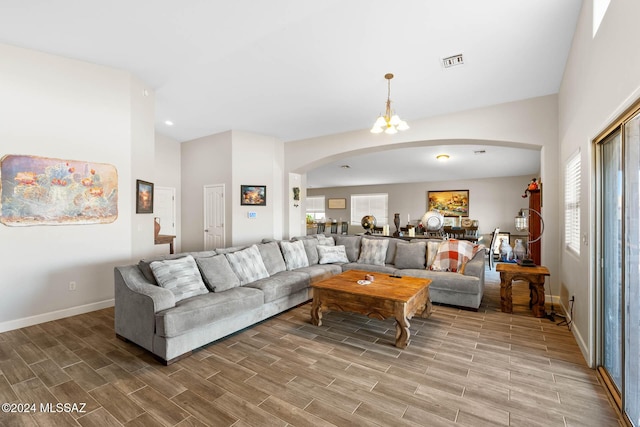 living room featuring an inviting chandelier and hardwood / wood-style flooring