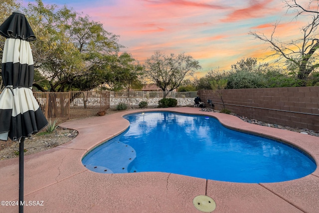 view of pool at dusk