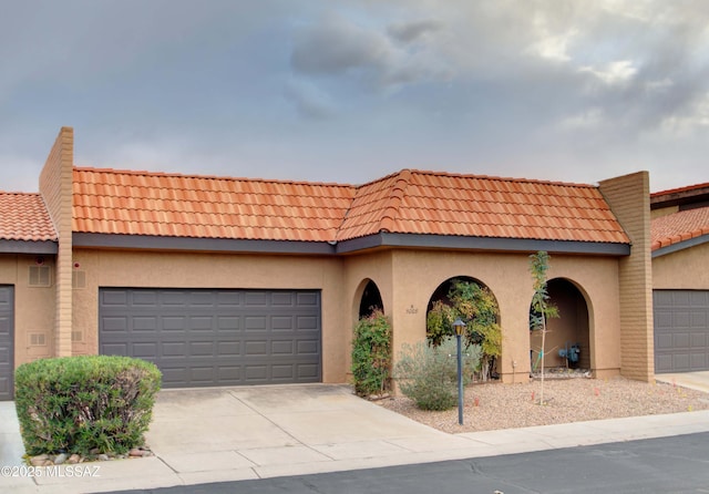 mediterranean / spanish home featuring a garage