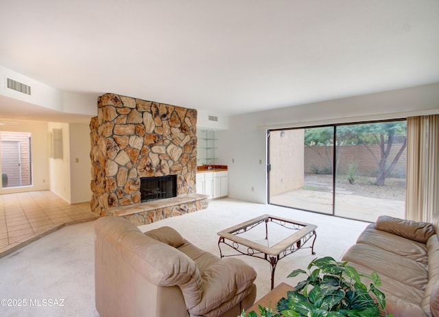 tiled living room featuring a fireplace